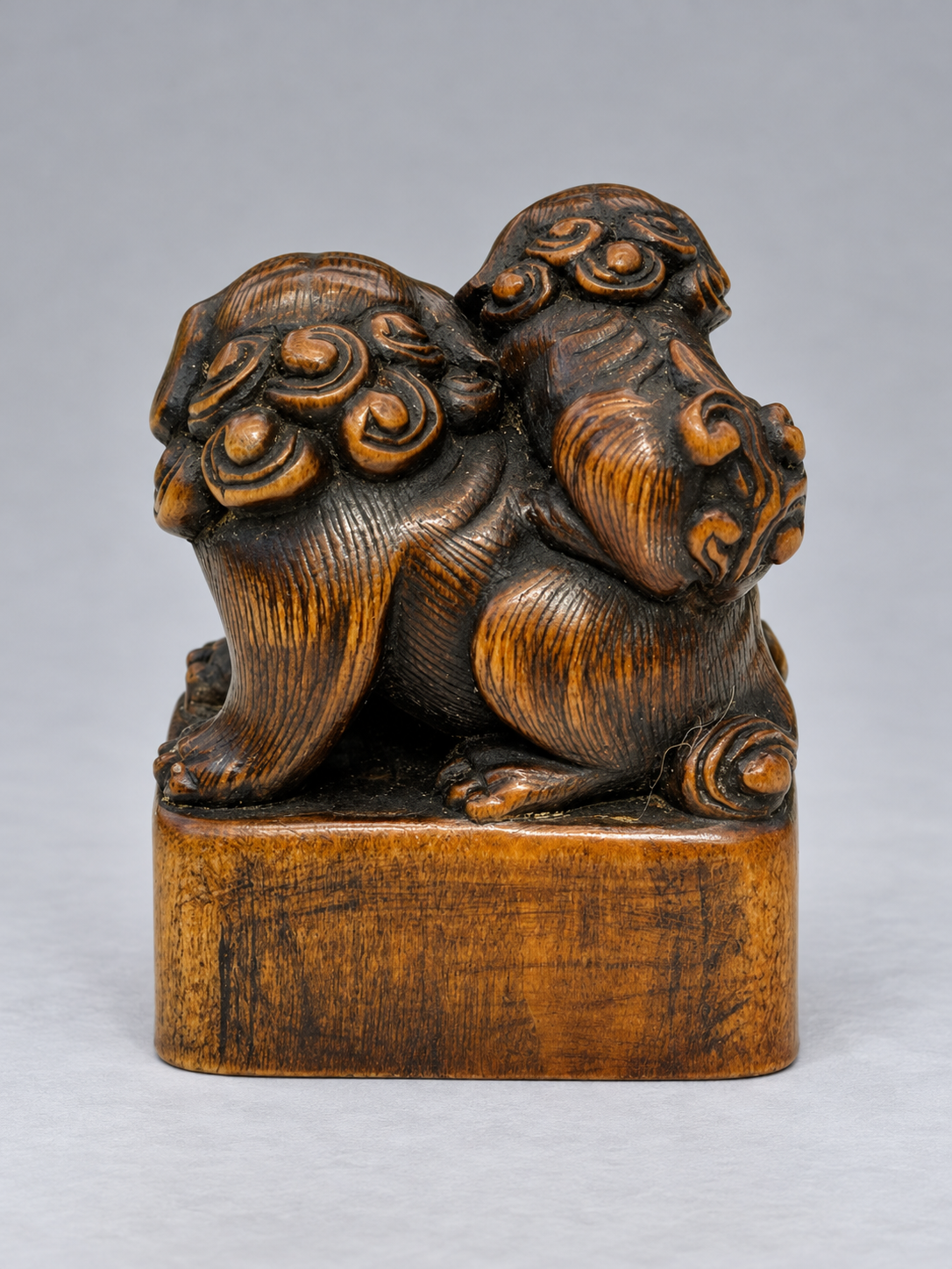 A Superb Wood Seal-Type (Ingyō) Netsuke of a Shishi and Cub
Japan, Meiji period (1868–1912)