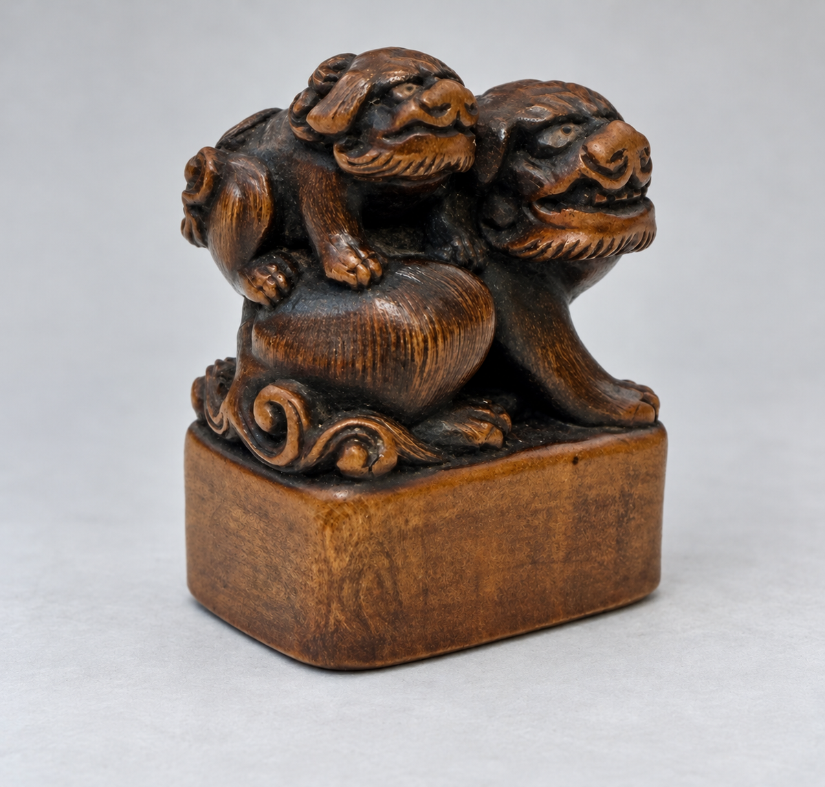 A Superb Wood Seal-Type (Ingyō) Netsuke of a Shishi and Cub

Japan, Meiji period (1868–1912)