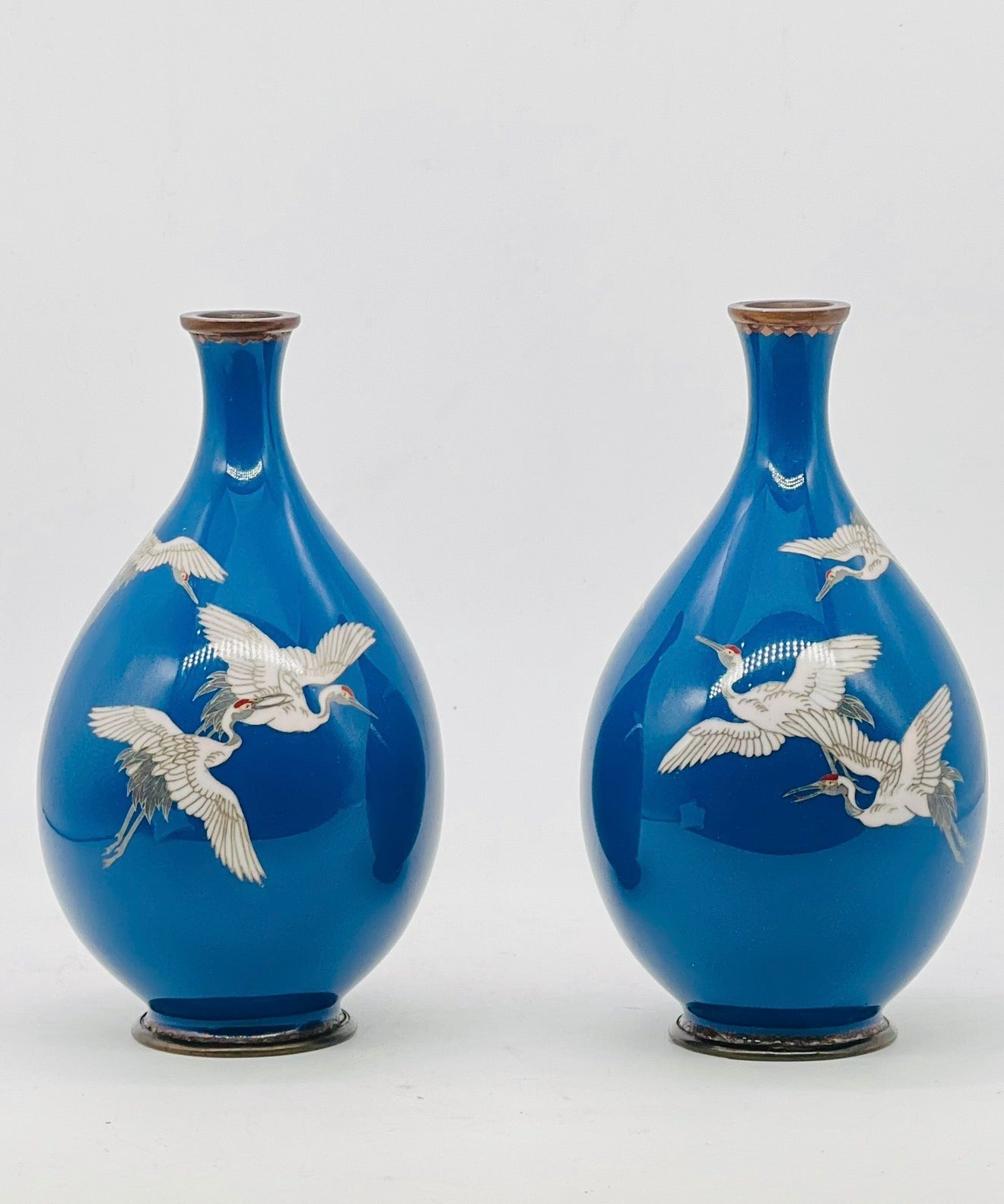A Fine Pair of Japanese Cloisonné Enamel Vases with Cranes on a Teal-Blue Ground, Meiji period