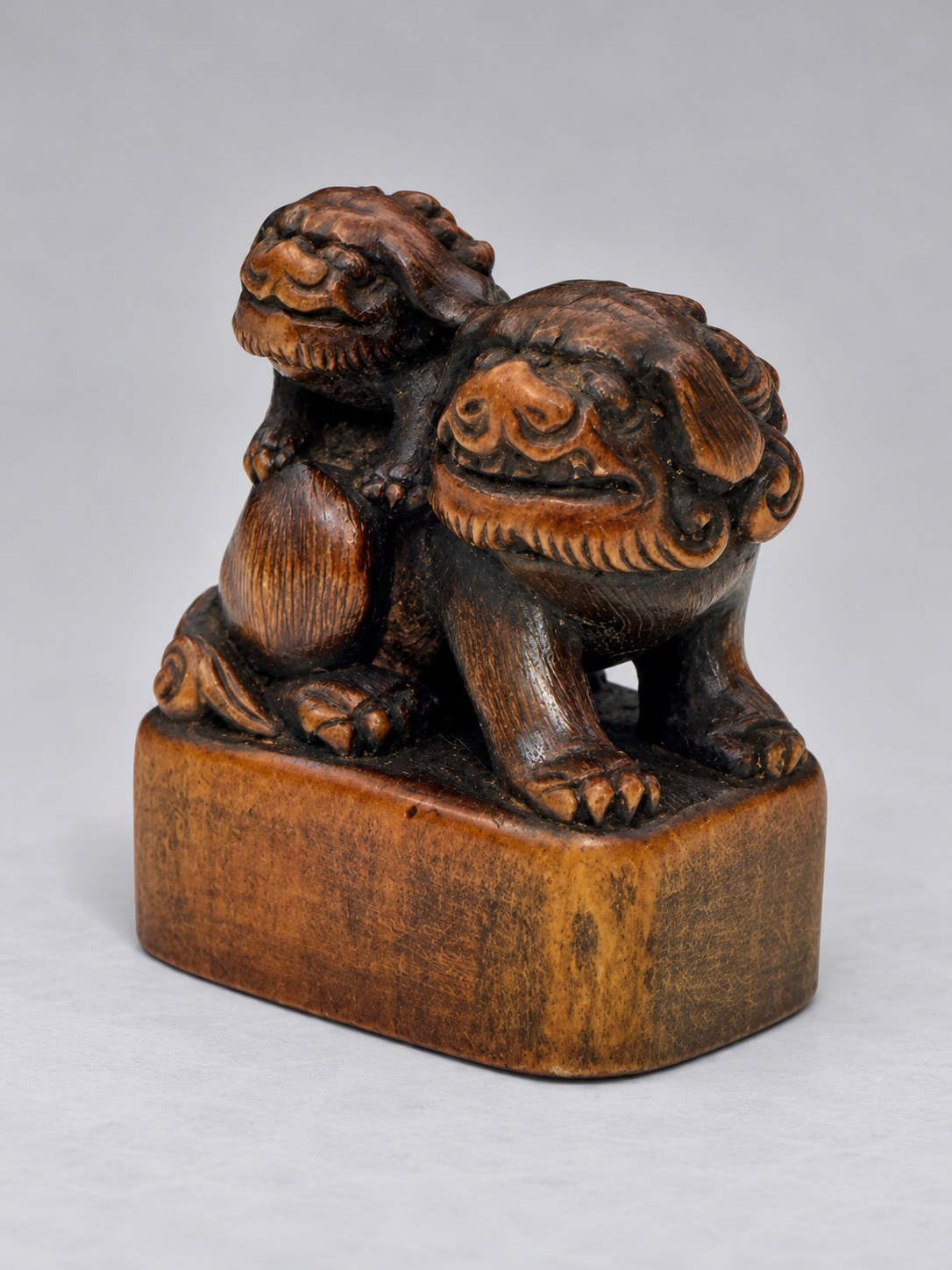 A Superb Wood Seal-Type (Ingyō) Netsuke of a Shishi and Cub

Japan, Meiji period (1868–1912)
