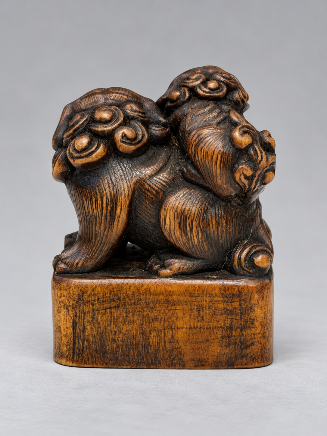 A Superb Wood Seal-Type (Ingyō) Netsuke of a Shishi and Cub

Japan, Meiji period (1868–1912)