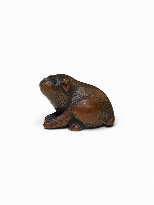A Japanese Wood Netsuke of a Seated Puppy-Signed Masanao (正直)Japan, Late Edo to Early Meiji period,