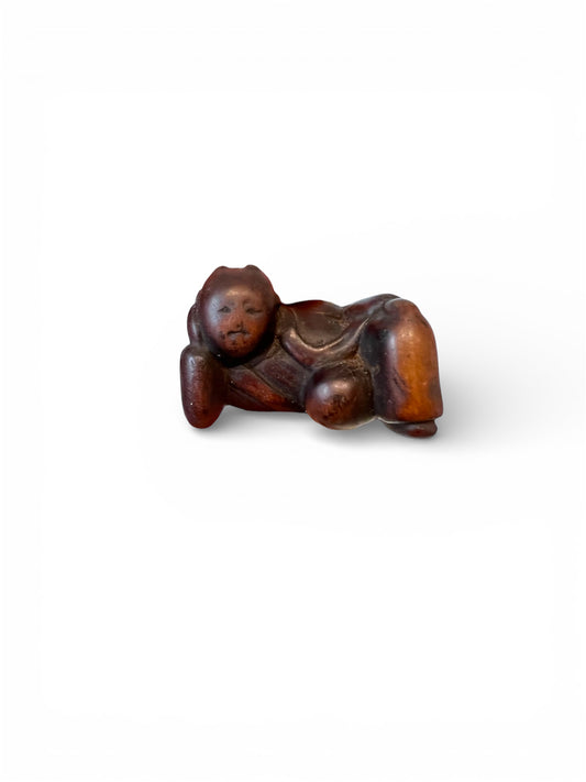 A Japanese wood netsuke of a reclining Karako (Chinese boy)
Edo period