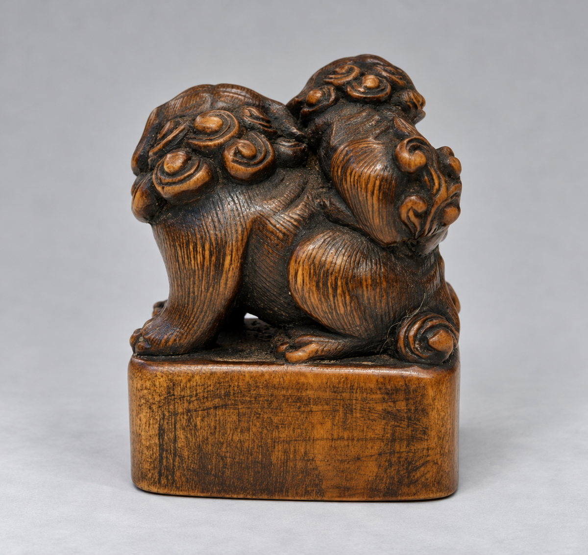 A Superb Wood Seal-Type (Ingyō) Netsuke of a Shishi and Cub

Japan, Meiji period (1868–1912)