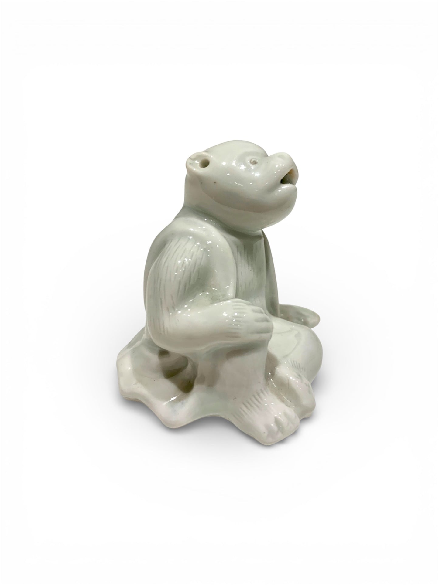 A Japanese Hirado Porcelain Suiteki (Water Dropper) in the Form of a Monkey
Meiji period,