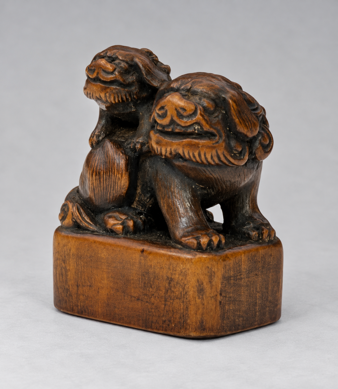 A Superb Wood Seal-Type (Ingyō) Netsuke of a Shishi and Cub

Japan, Meiji period (1868–1912)