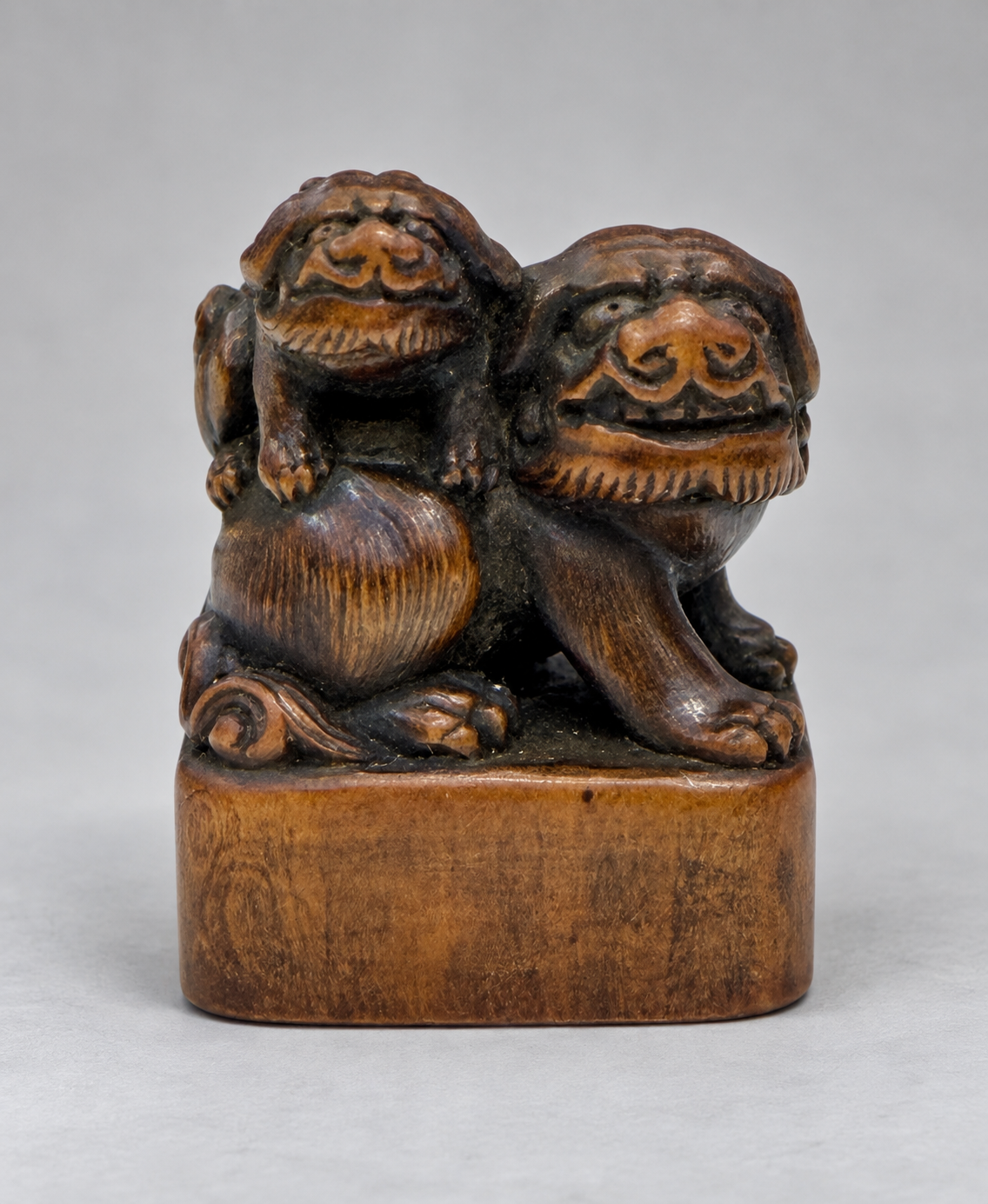 A Superb Wood Seal-Type (Ingyō) Netsuke of a Shishi and Cub

Japan, Meiji period (1868–1912)