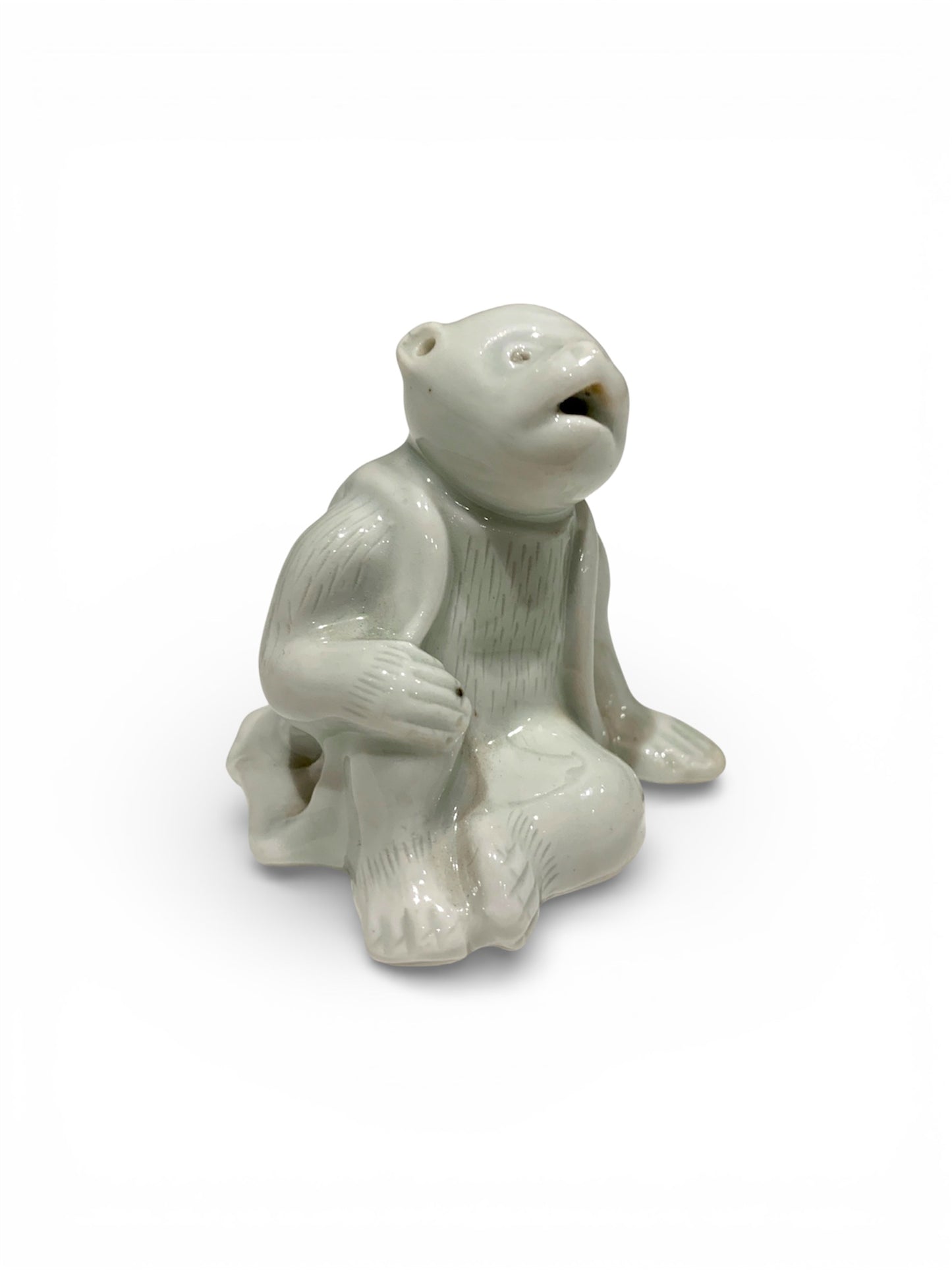 A Japanese Hirado Porcelain Suiteki (Water Dropper) in the Form of a Monkey
Meiji period,