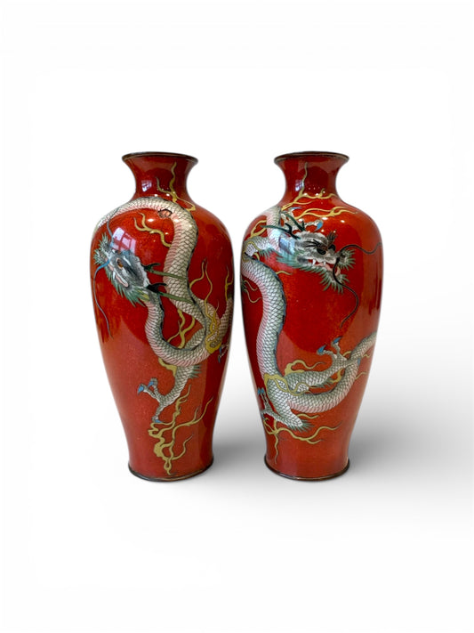 A fine pair of Japanese cloisonné enamel vases decorated with dragons on a rich red ground, Meiji period